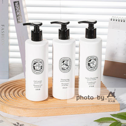 DIPTYQUE shampoo and conditioner and body lotion on table
